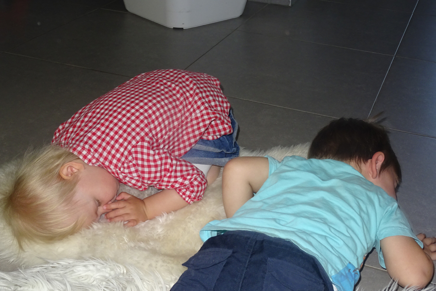 zwei Kinder schaffen sich Ruheinseln mit Schaffellen